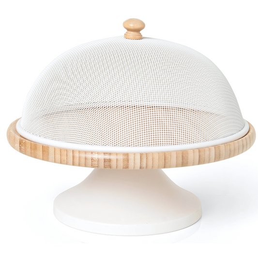 Porta bolo de metal na cor branca da linha Enjoy, sobre uma mesa.